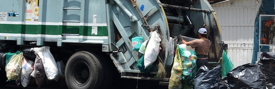 Waste being collected by a refuse truck